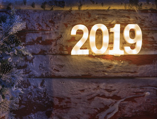 Happy New Year 2019.Symbol from number 2019 on snowy wooden background.