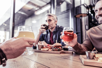 Close up of male hands that holding glasses