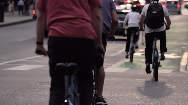 people riding a bike in the city to go to work. Sustainable transportation concept, smart people that cycle go faster than cars