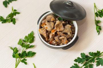 stewed chicken stomachs with vegetables and buckwheat in a bowl