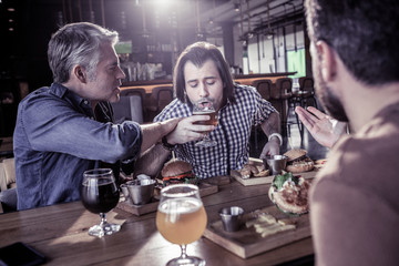 Upset male person trying to drink beer