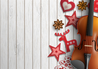 Violin and Christmas ornaments on white wood