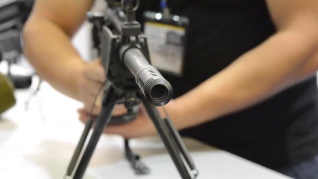 Several large-caliber weapons on the table. Firearms gun submachine sniper rifle close-up.
