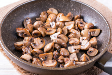Sliced mushrooms stir-fried in a pan