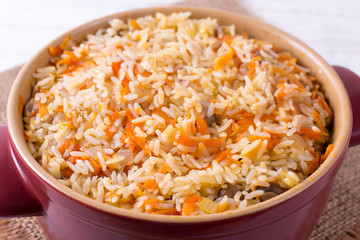 Porridge in a saucepan on the wooden table, close up, horizontal