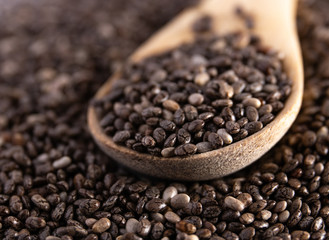 Macro view of chia seeds in a wood spoon