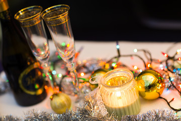 New years eve celebration background with champagne and a pair of glasses with christmas decoration. Party and celebration concept.