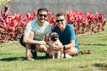 Two men in the park with their pet