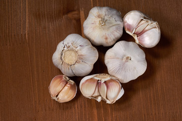 Garlic and garlic cloves on wooden background. Selective focus