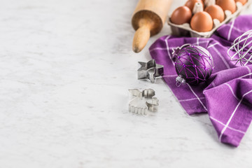 Christmas baking purple gifts decorations eggs and kitchen utensil.