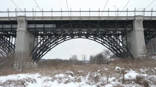 Bloor Viaduct with subway train passing. Winter in the Don Valley, Toronto, Canada.