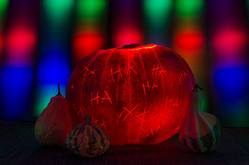 Halloween Pumpkin with Hahaha Carved and Curtain of Light behind
