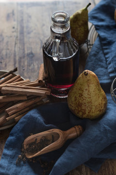 Fresh pears near spices and wine