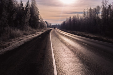 snowy winter road glitters in the sun