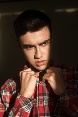 The portrait of young white boy looking aside posing isolated over green wall background