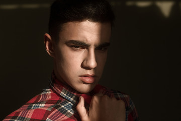 The portrait of young white boy looking camera posing isolated over green wall background