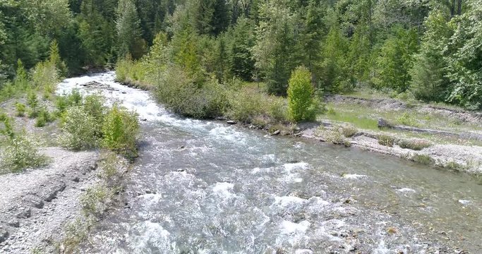 Majestic mountain river in Devis Creek, Vancouver, Canada. Drone flying. Aerial view with mountain background.
