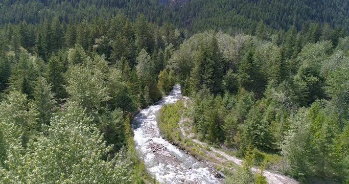 Majestic mountain river in Devis Creek, Vancouver, Canada. Drone flying. Aerial view with mountain background.