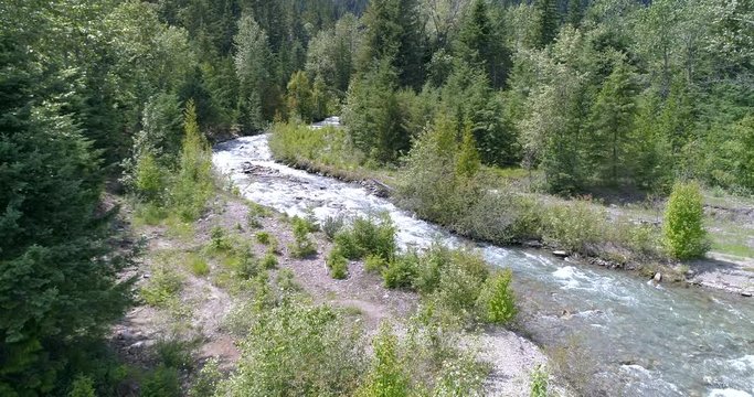 Majestic mountain river in Devis Creek, Vancouver, Canada. Drone flying. Aerial view with mountain background.