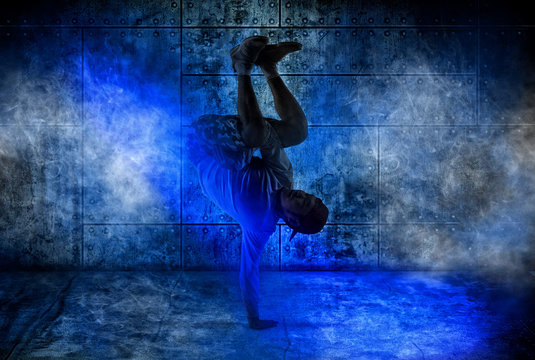 Man break dancing on dark