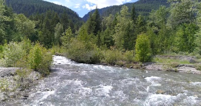 Majestic mountain river in Devis Creek, Vancouver, Canada. Drone flying. Aerial view with mountain background.