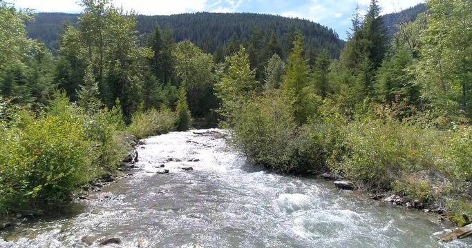 Majestic mountain river in Devis Creek, Vancouver, Canada. Drone flying. Aerial view with mountain background.