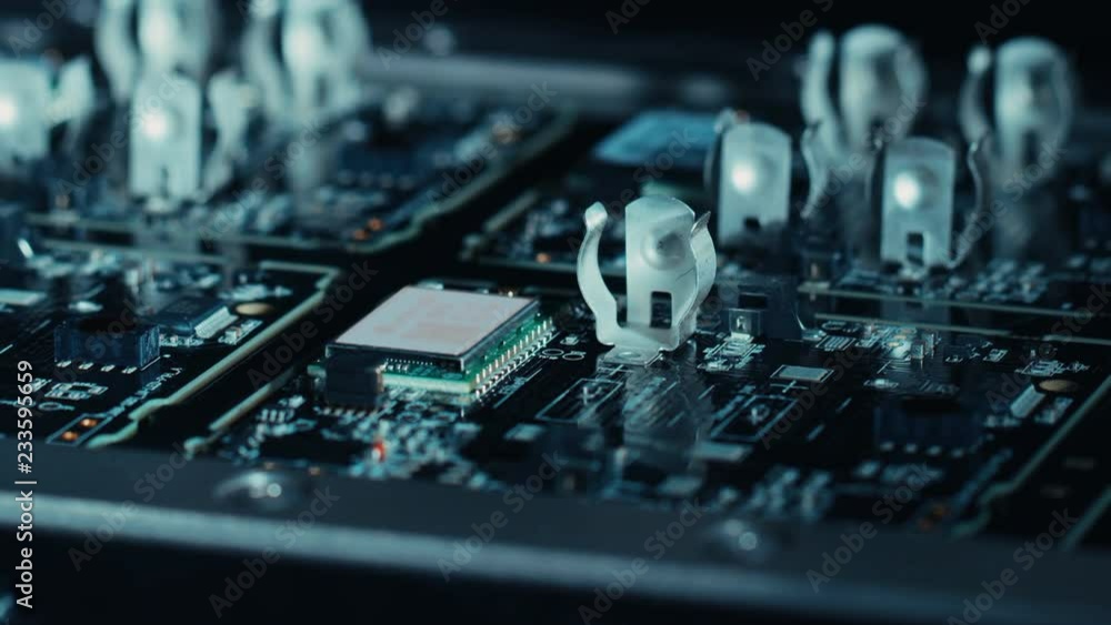 Poster close-up macro shot of electronic printed circuit board being assembled with automated robotic arm, 
