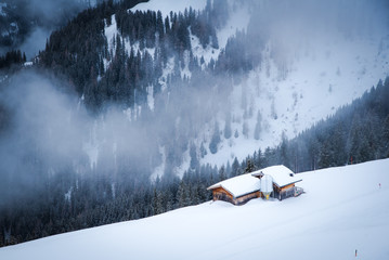 Alpine lodge and a snowy landscape