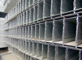 Metal profile for drywall laid on the racks of the warehouse