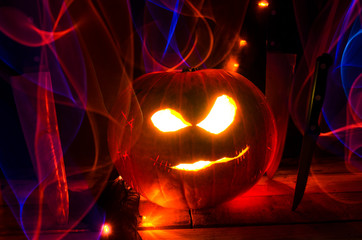 Carved Halloween Pumpkin with Glowing Lights and Knives