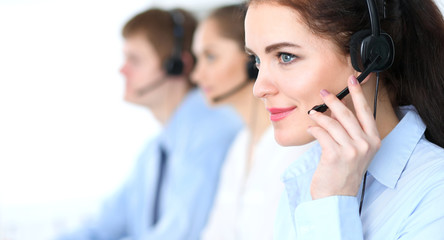 Call center operators at work. Focus at  business woman in headset