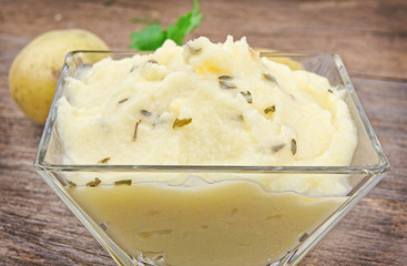 Mashed potatoes on wooden table