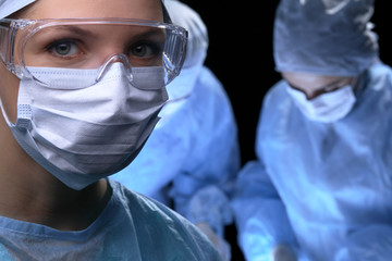 Medical team performing operation. Focus at female doctor 