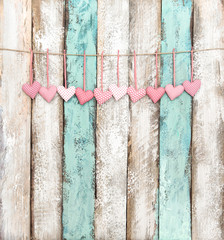 Pink hearts decoration hanging wooden background