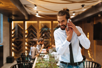 Young businessman talking on the phone at a business meeting