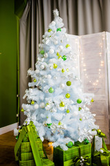 White Christmas tree with gifts in green boxes