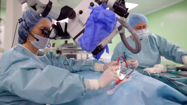 Surgeon performing difficult operation on ear improving hearing using modern medical technologies.