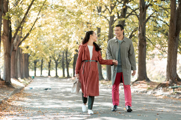 Fototapeta premium Relaxed loving couple walking after dinner in cafe