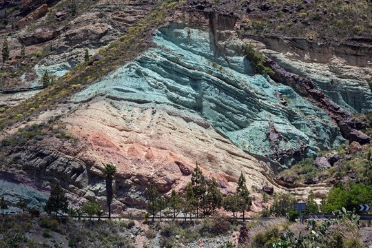 Turquoise colored rock layer Los Azulejos De Veneguera, volcanic rock steeped in sodium iron silicate, at Mogan, Gran Canaria, Canary Islands, Spain, Europe