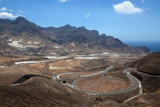 View of the townsmall La Aldea de San Nicolas de Tolentino and the barren mountains Montana de Horgazales, highway, Gran Canaria, Canary Islands, Spain, Europe