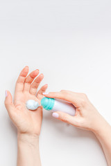 Woman moisturizing her hands with foam lotion