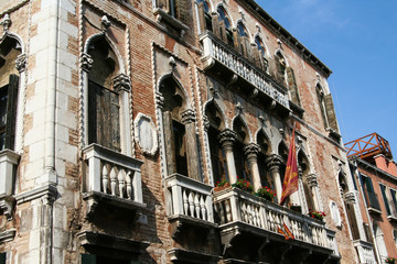 Fototapeta na wymiar Venice, brick building facade with balconies