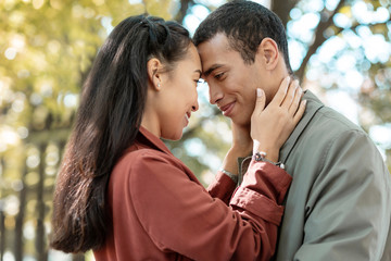 Beautiful longhaired girl embracing her young man