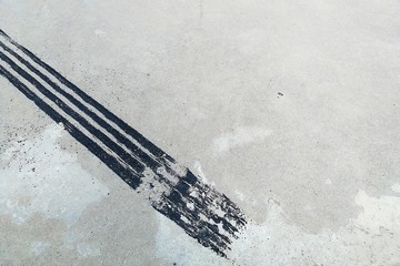 black tire track on dirty concrete after sudden brake