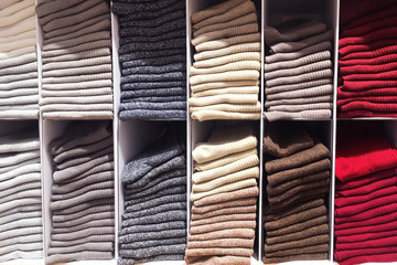 Socks on sale in department store. Shelves with different color socks in a clothing store.