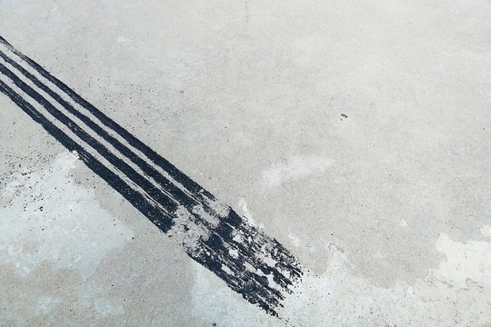 Black Tire Track On Dirty Concrete After Sudden Brake