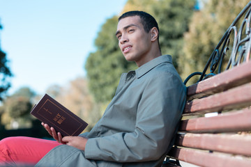 Pleased male person having break during walk