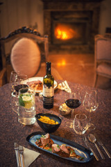 food and wine in restaurant, winter time, romantic dinner with fireplce