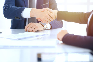 Group of business people or lawyers shaking hands finishing up a meeting , close-up. Success at negotiation and handshake concepts