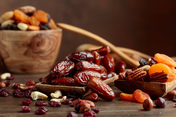 Various dried fruits and nuts in wooden dish.